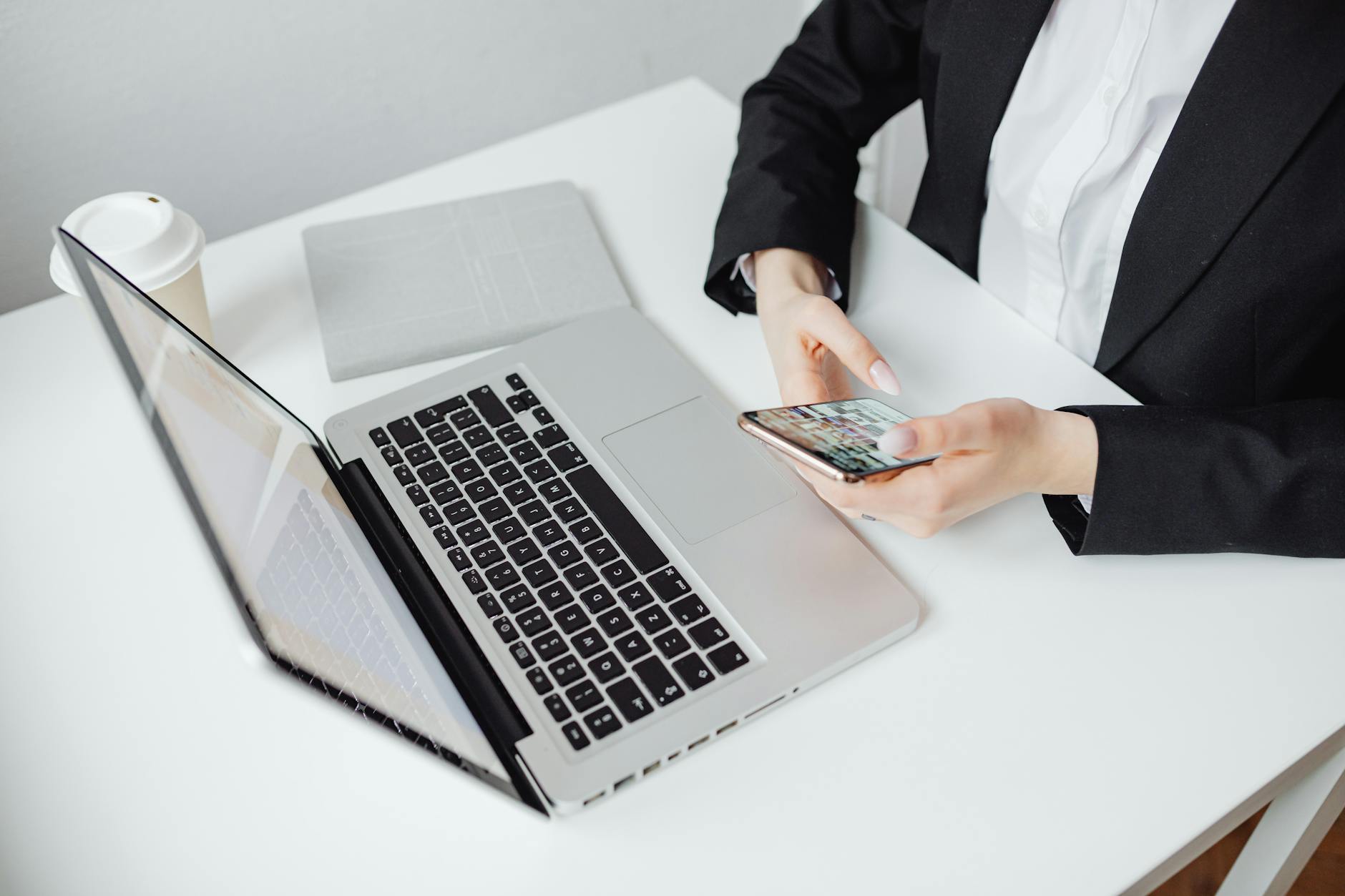 https://www.pexels.com/photo/person-in-black-blazer-holding-a-smartphone-7679642/