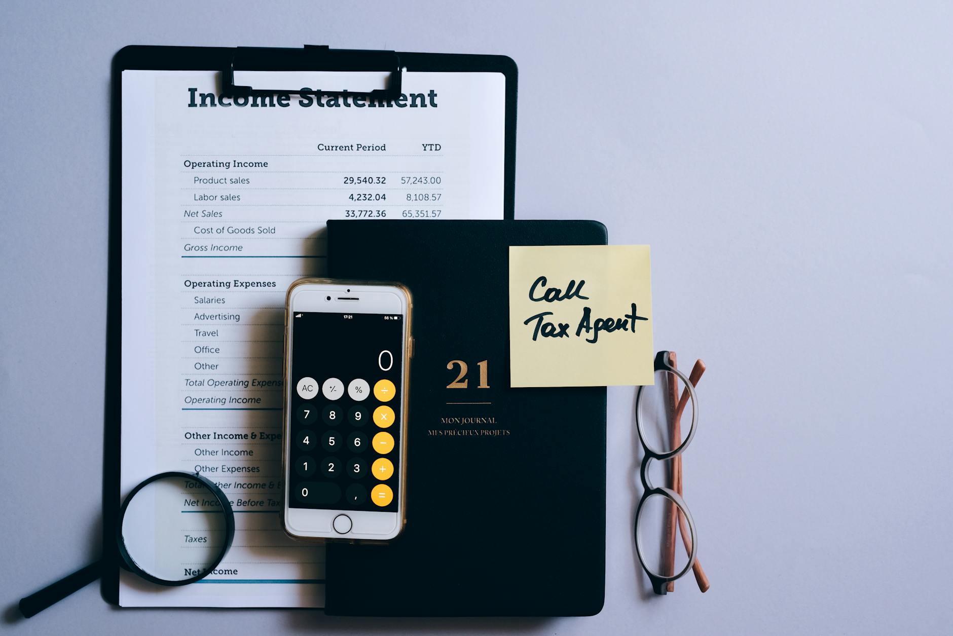 https://www.pexels.com/photo/smartphone-with-opened-calculator-lying-on-a-document-with-an-income-statement-8962520/